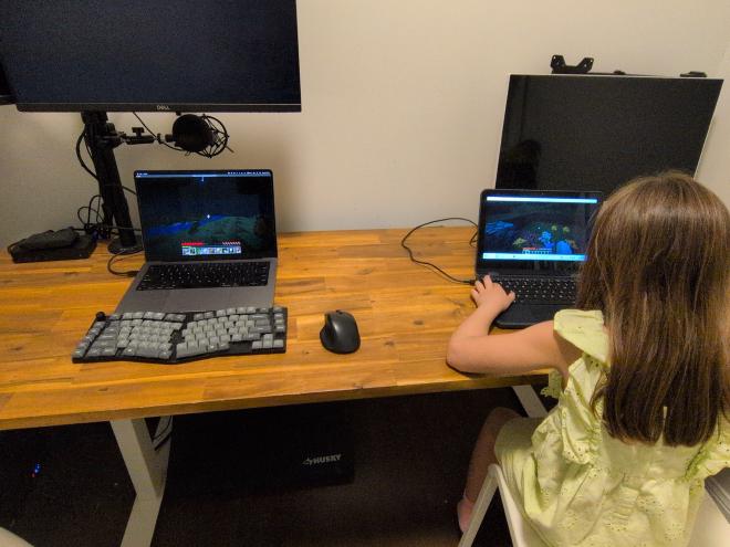My daughter playing Minecraft with me on our home LAN server